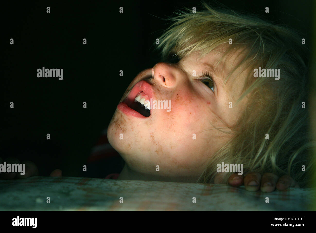 portrait of a blond boy dirty face looking upward straggly Stock Photo