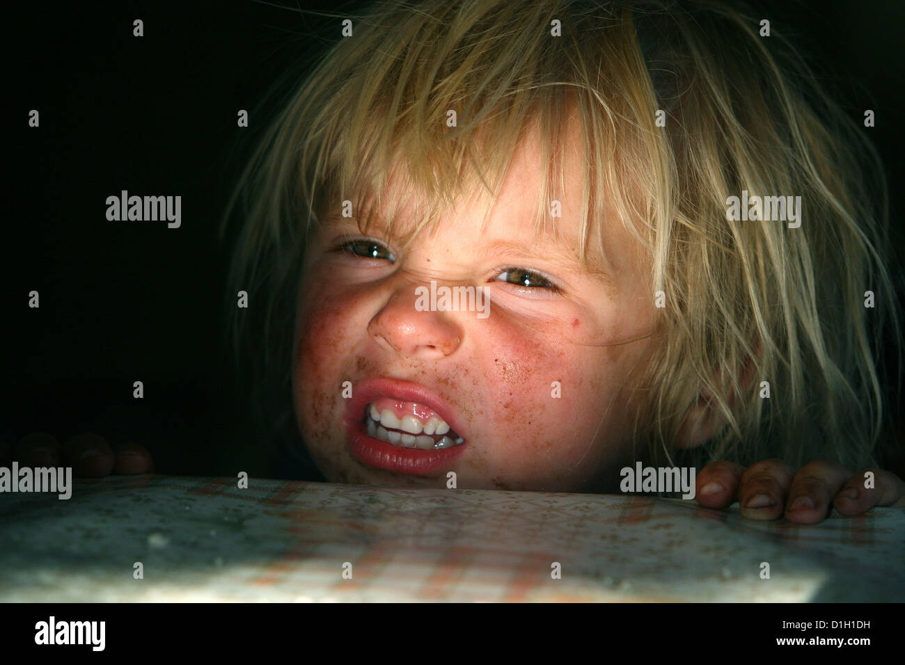portrait of a blond boy dirty face toddler, child, kid 3-4 years old, grimace, teeth child face expression Stock Photo