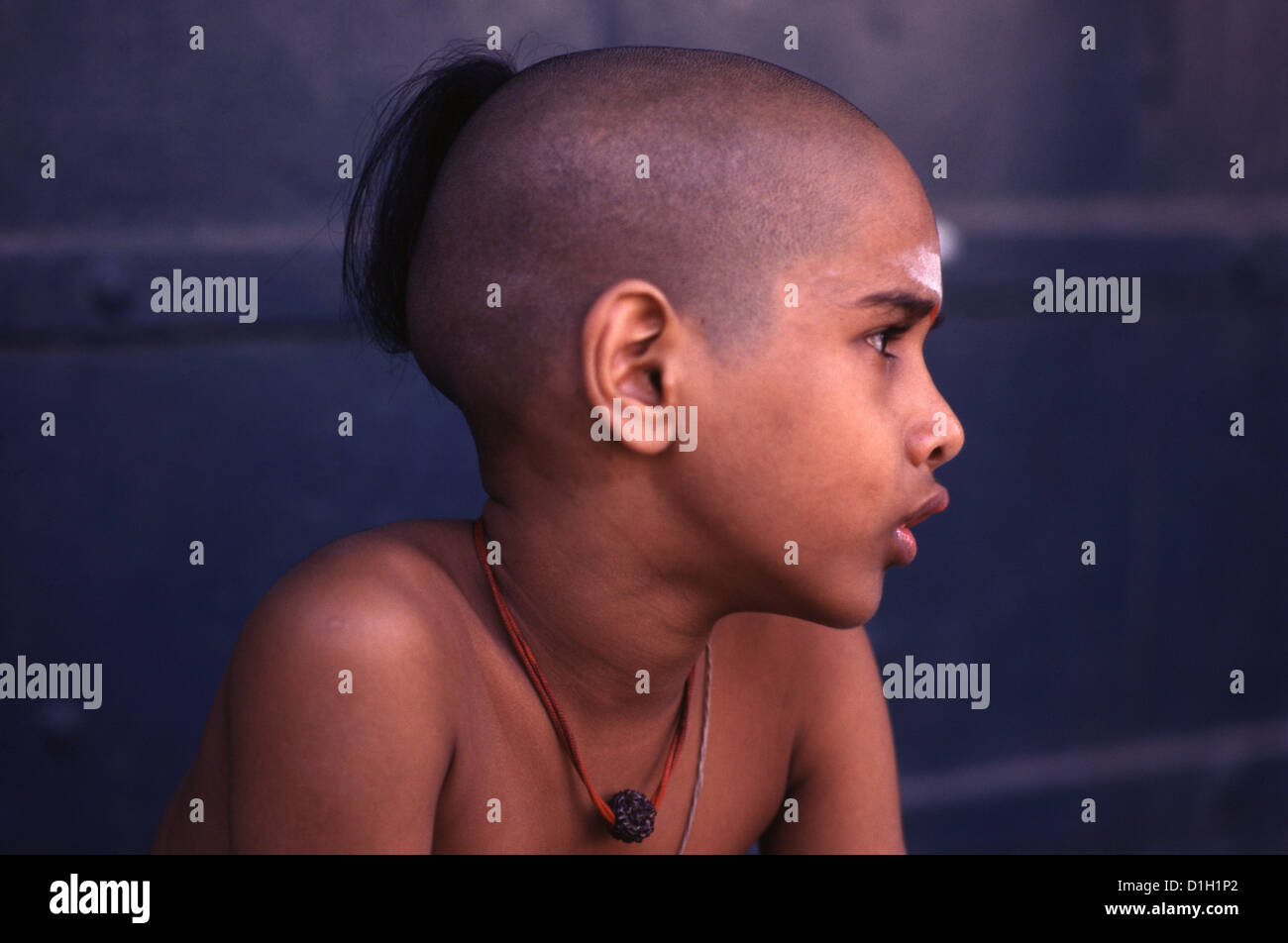 A young Brahmin novice with lock of hair, left on the back of his shaven head in Tamil Nadu India Stock Photo