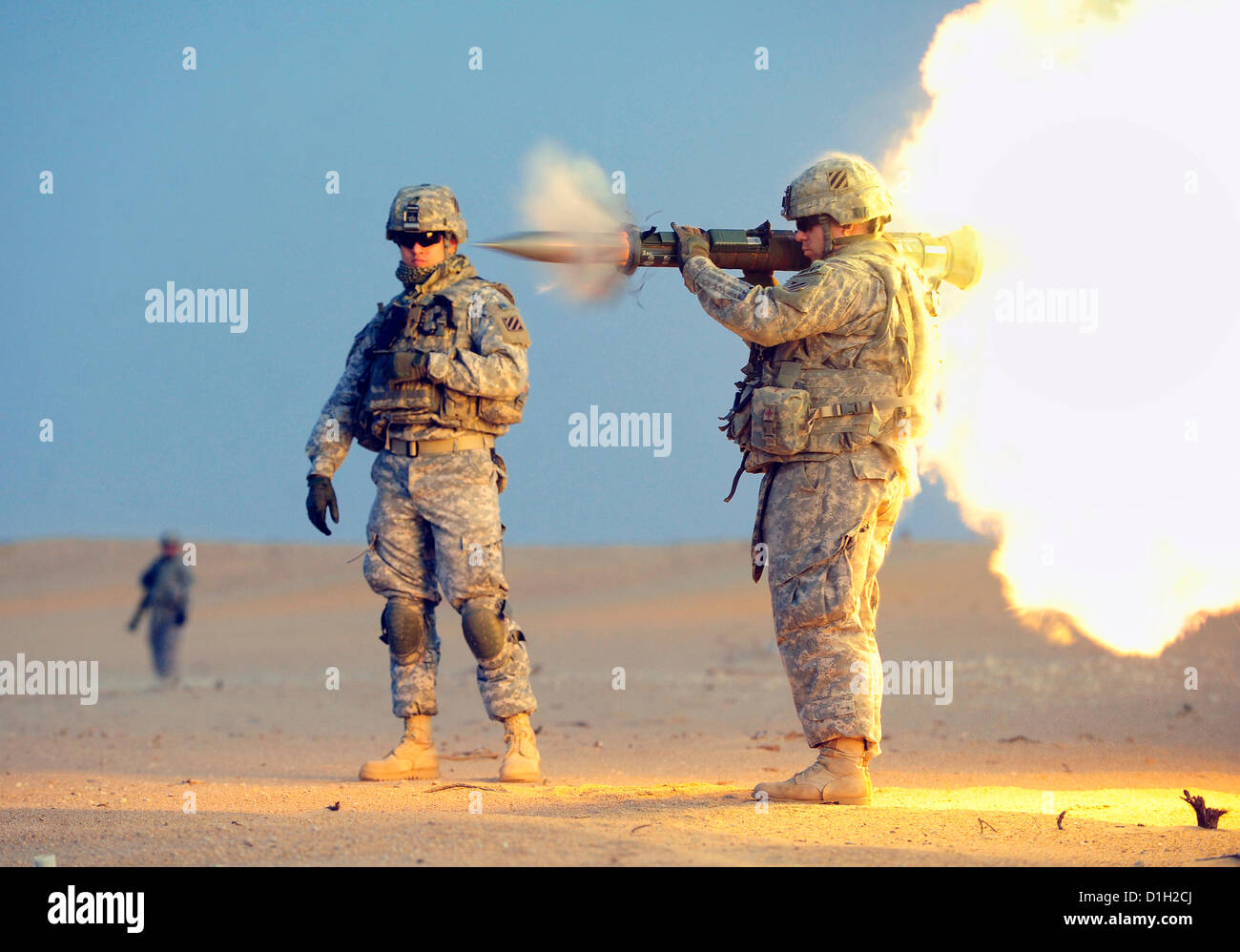 A US Army soldier fires an AT-4 anti-tank weapon during training at the Udairi Range Complex December 20, 2012 near Camp Buehring, Kuwait. The AT-4 is a portable, single-shot recoilless smoothbore weapon used to destroy heavily armored vehicles. Stock Photo