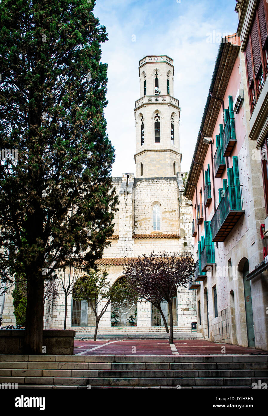 St. Pere Church tower across a plaza in Figueres, Spain. This medieval church was Salvadore Dali's family church. Stock Photo