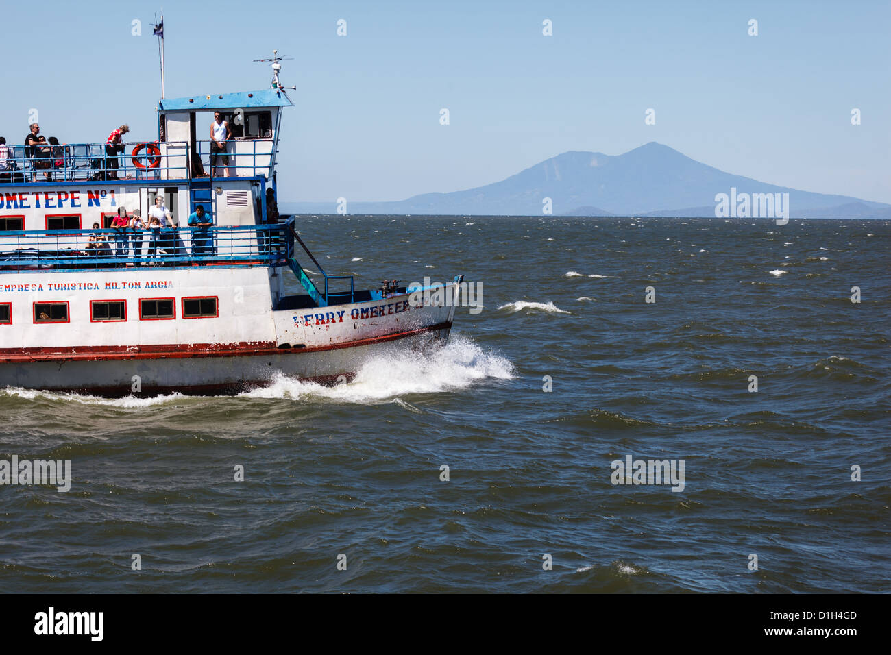 Passenger Ferry crossing lake to Ometepe Island where you can see Conception volcano rising in the background Stock Photo