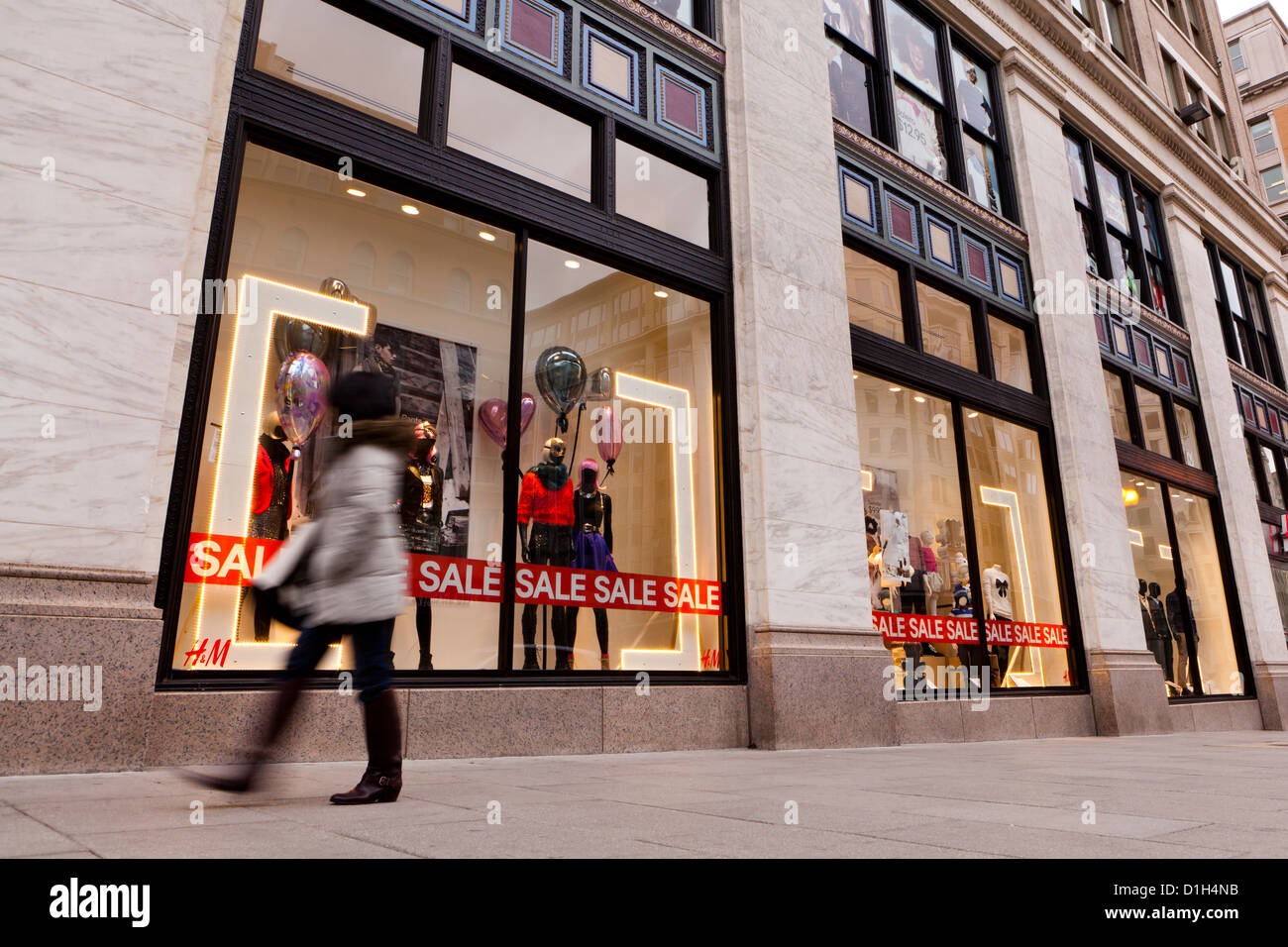 Woman walking by H&M clothing store window display - Washington, DC USA  Stock Photo - Alamy