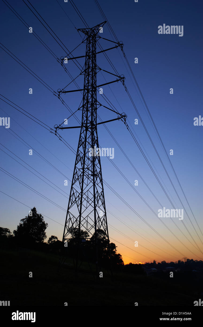 Silhouetted high voltage electricity pylon Stock Photo
