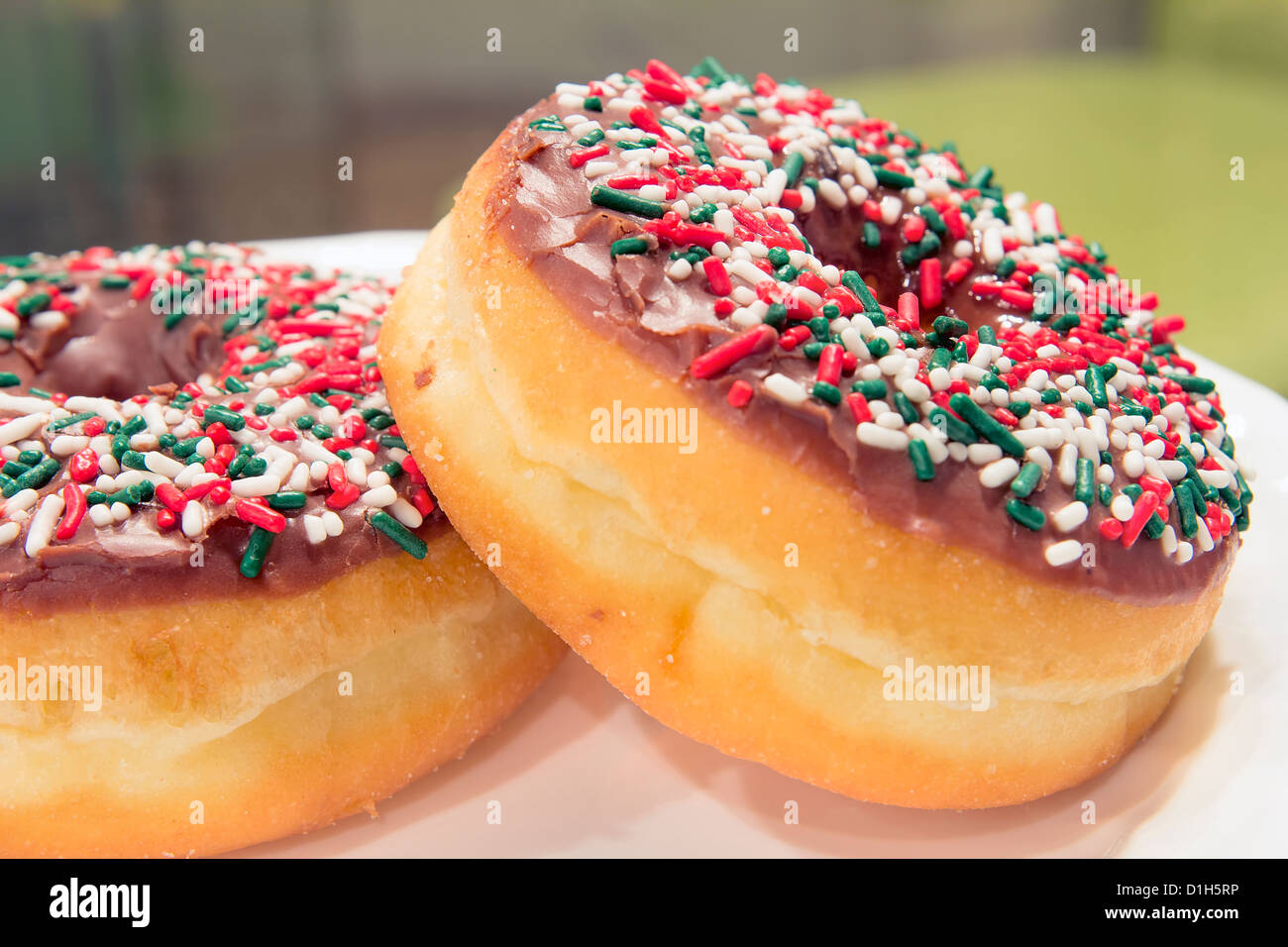 Donuts with Christmas Red Green and White Sprinkles Closeup Stock Photo