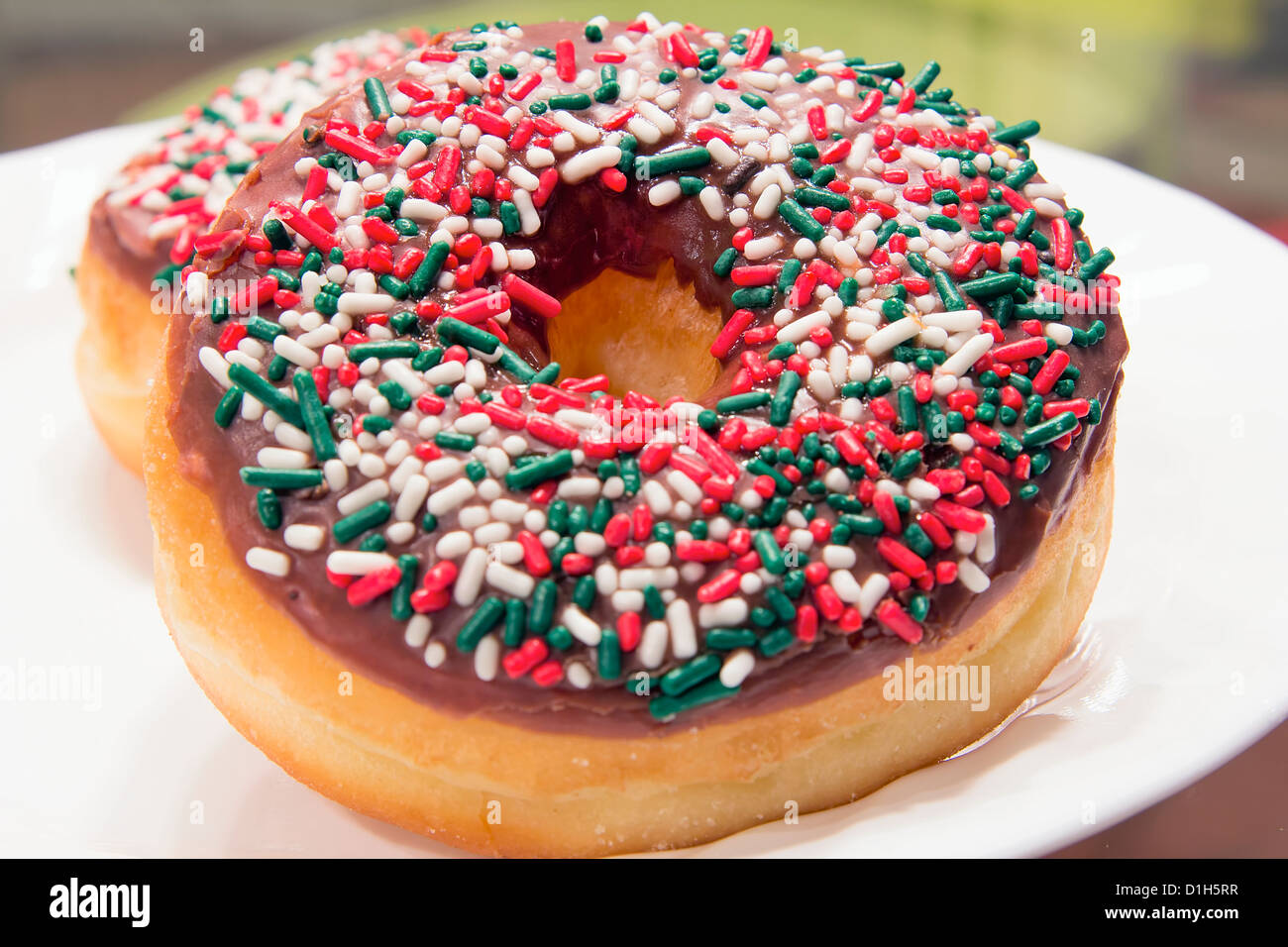 Doughnuts with Christmas Red Green and White Sprinkles Front Closeup Stock Photo