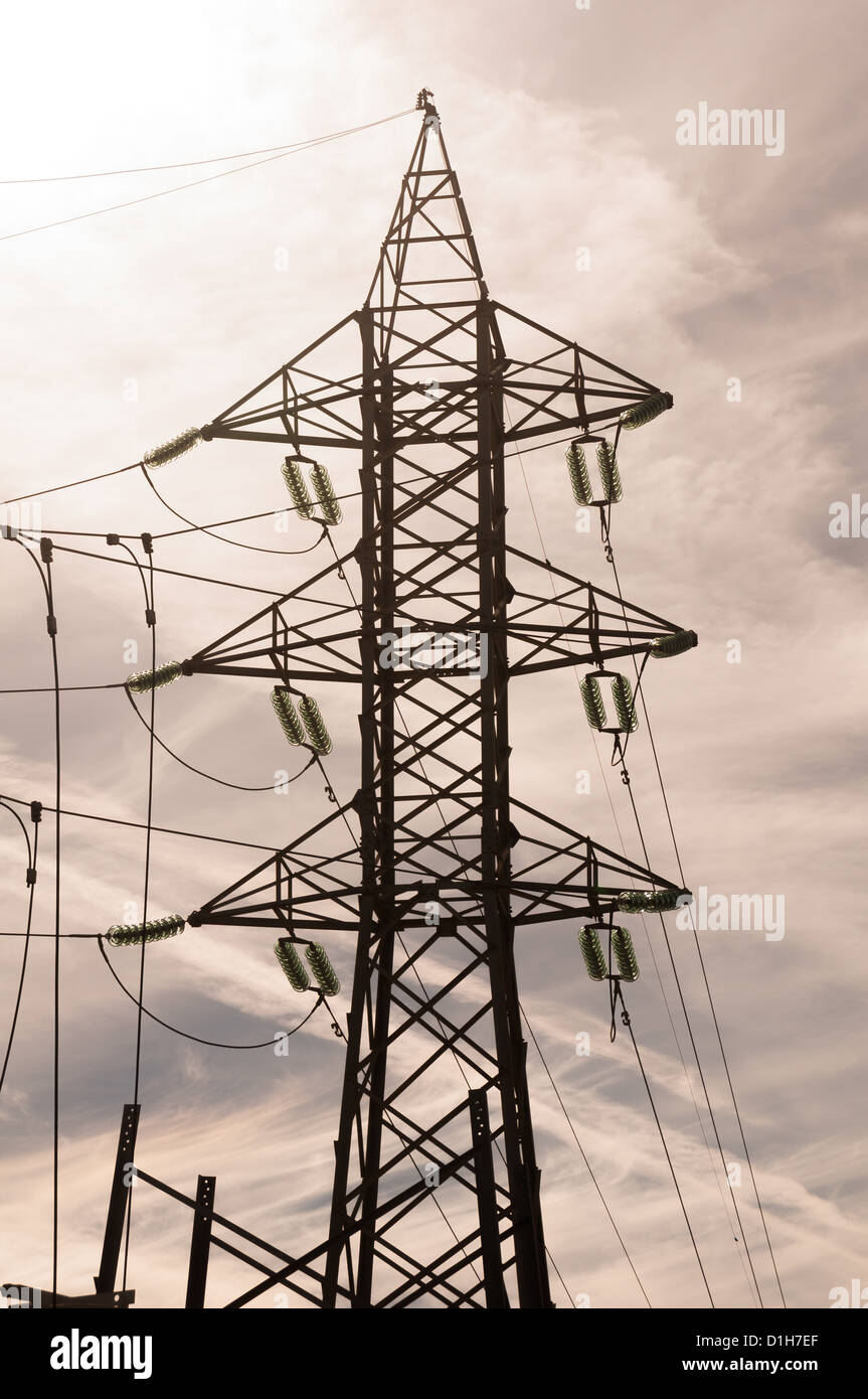 electricity pylon against a cloudy sky Stock Photo
