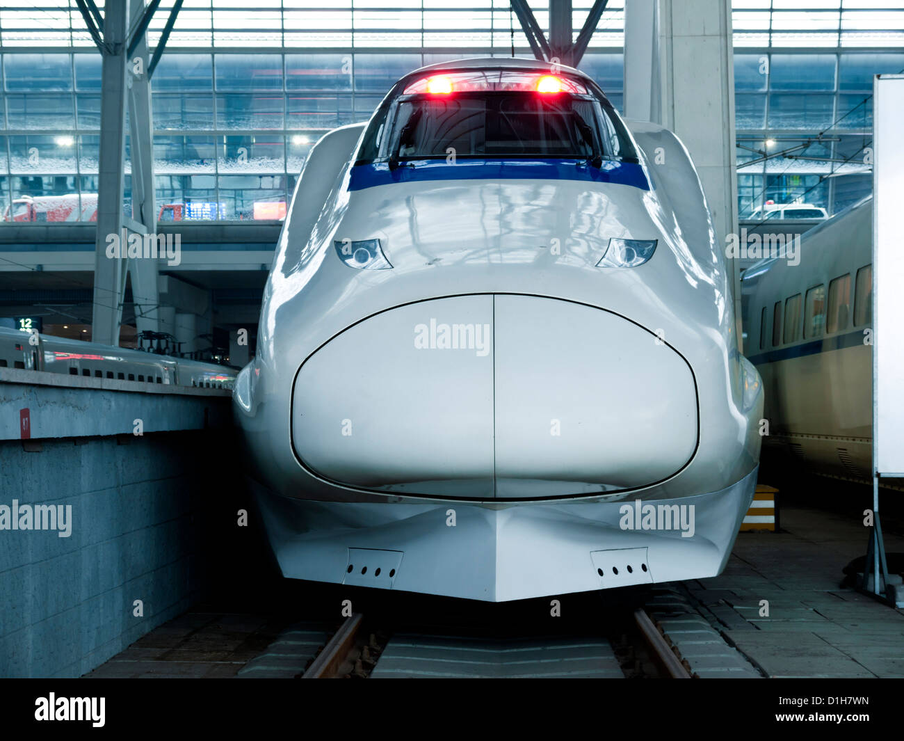 Front view of high-speed train stopped at train station. Stock Photo