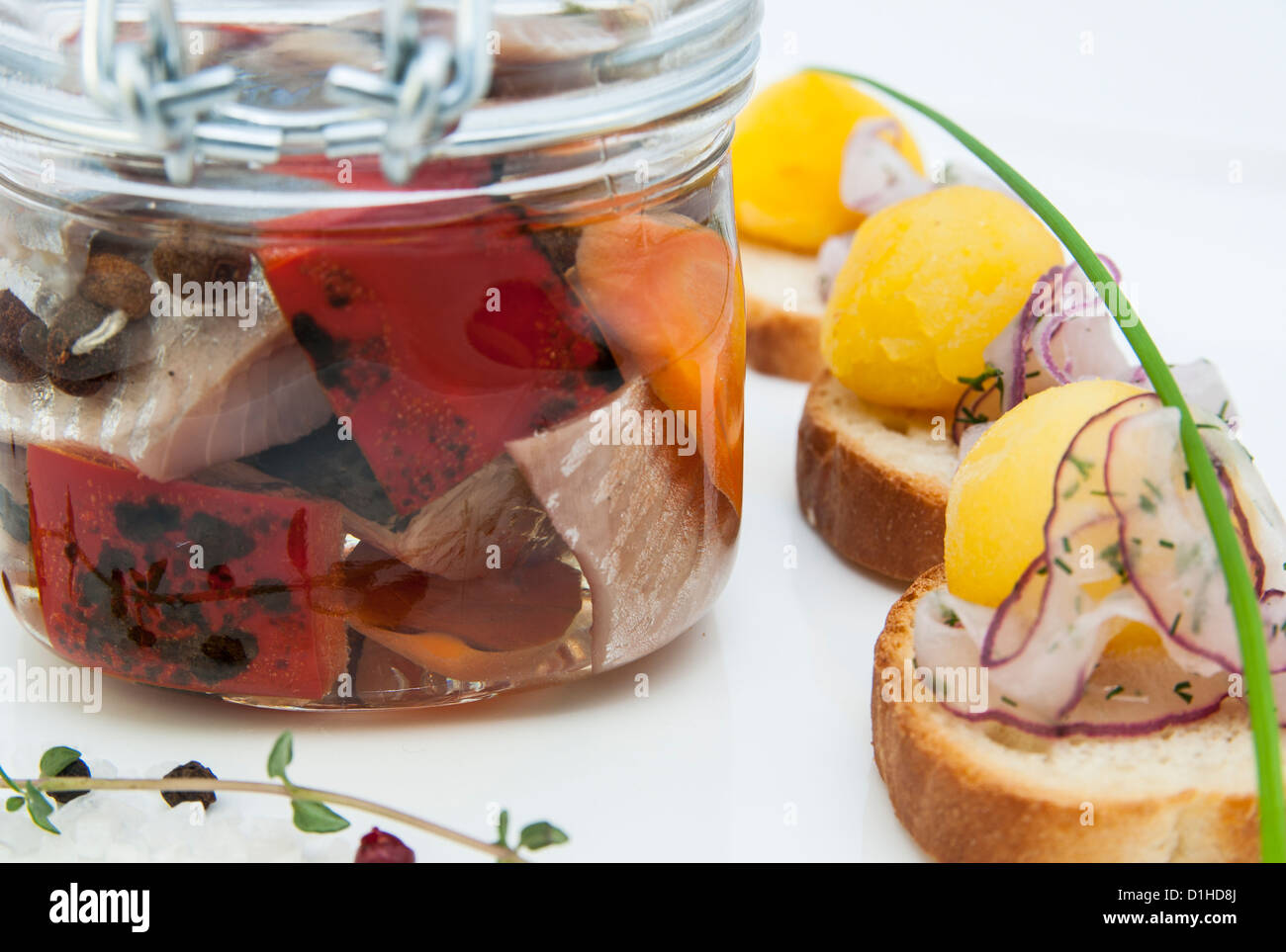 pickled herring in a glass jar with potato canapes Stock Photo Alamy