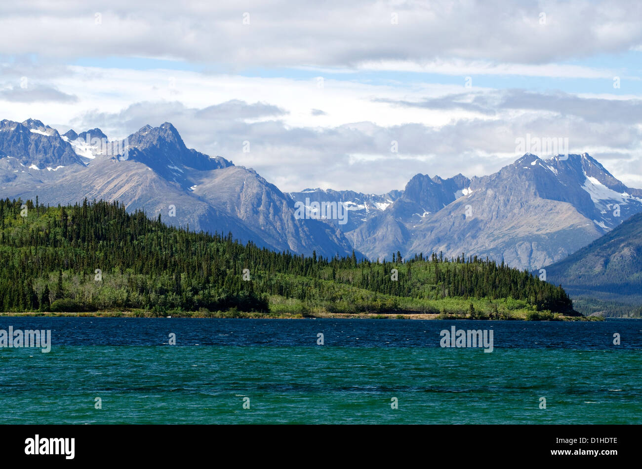 Looking across Bennett Lake at large mountain peaks in the town of Carcross in the Yukon Territory, Canada. Stock Photo