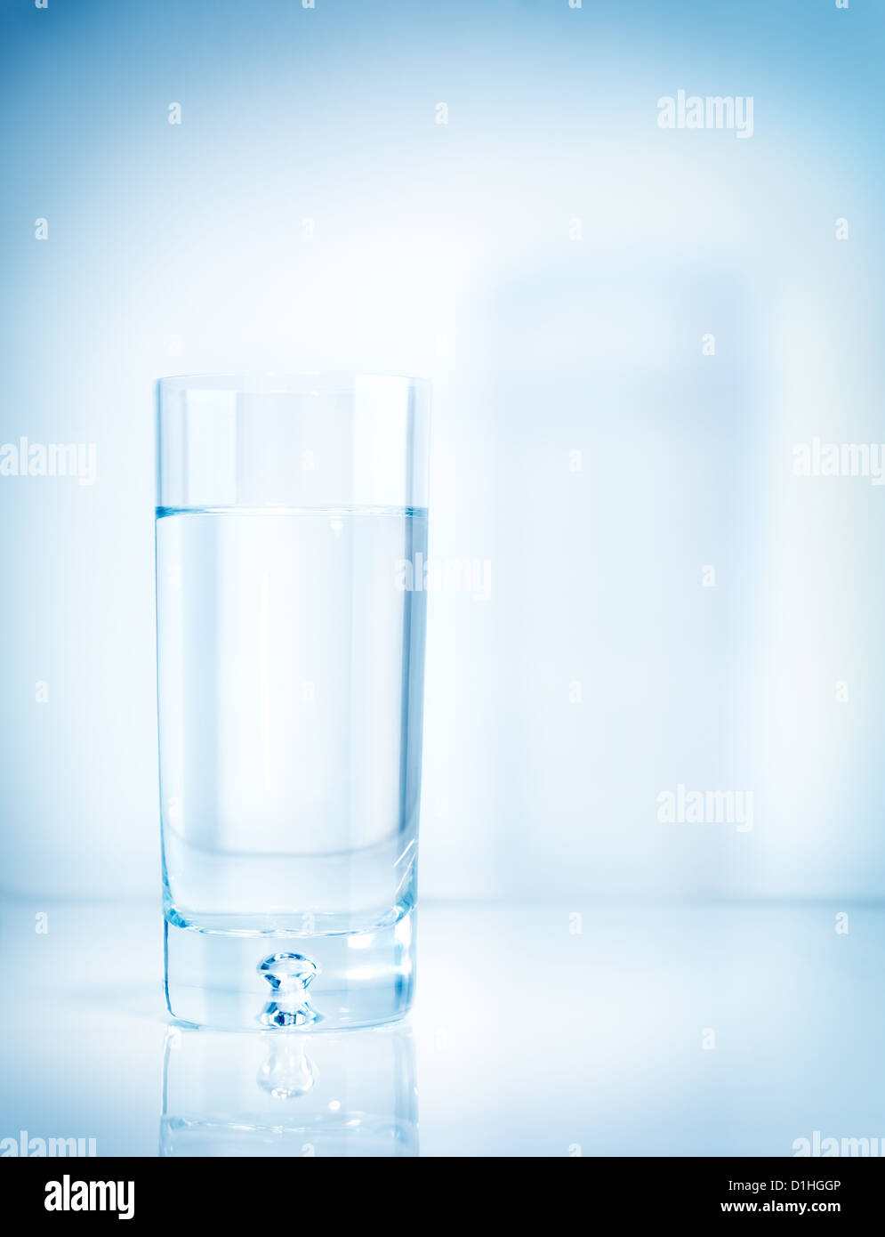 Glass of drinking water isolated on light blue background Stock Photo