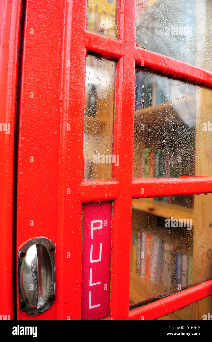 Red Telephone Box,Book Exchange .Hoveringham Nottinghamshire. Stock Photo