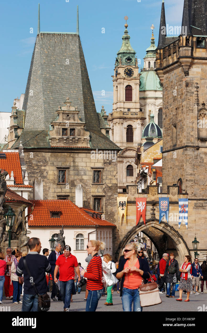Tourists walking across Charles Bridge, Prague, Czech Republic. View to the Judith Bridge Tower and the Mala Strana Bridge Tower Stock Photo