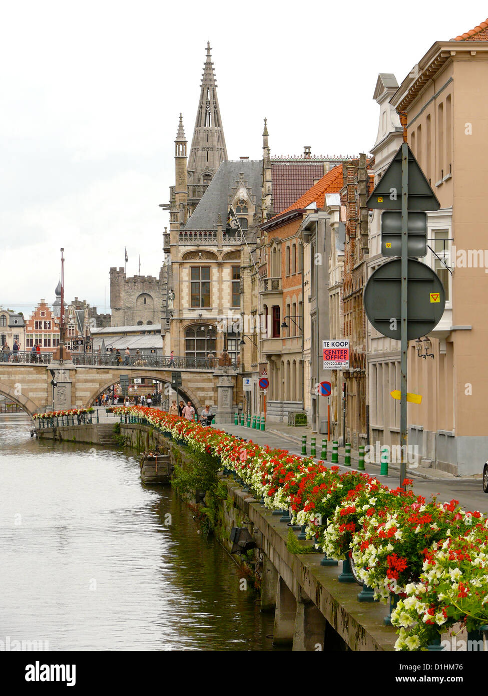 A nice and thriving view of city centre of Gent (Gand),Belgium, along the main channel of the city with flowers and dome Stock Photo
