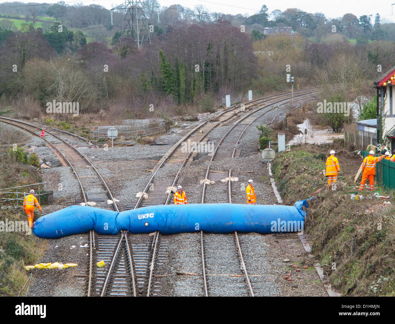 Firemen and Rail workers erect a second water dam across the Exeter to