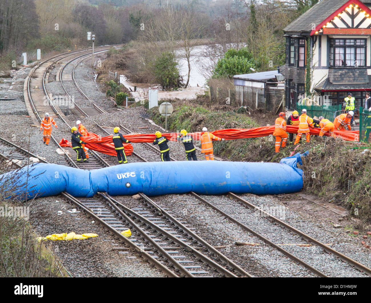 Firemen and Rail workers erect a second water dam across the Exeter to
