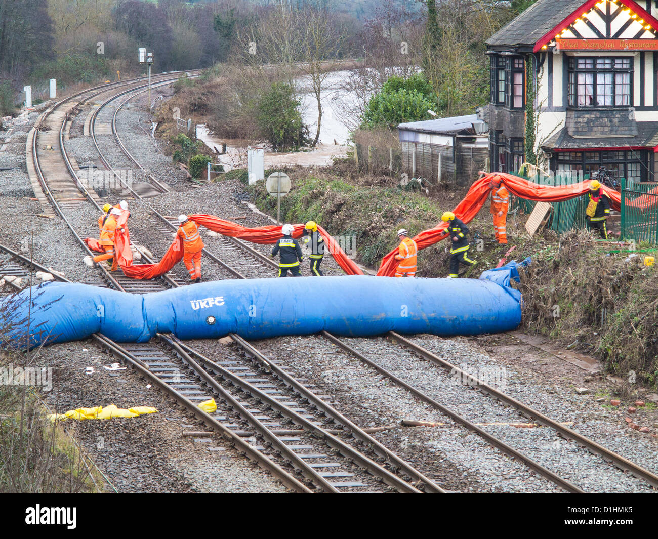 Firemen and Rail workers erect a second water dam across the Exeter to