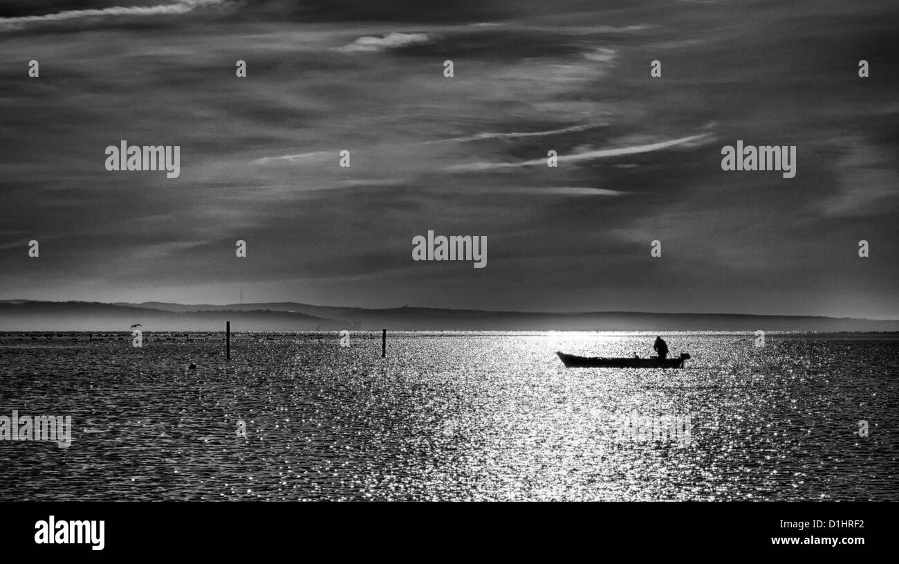 Fisherman in wooden boat Black and White Stock Photos & Images - Alamy