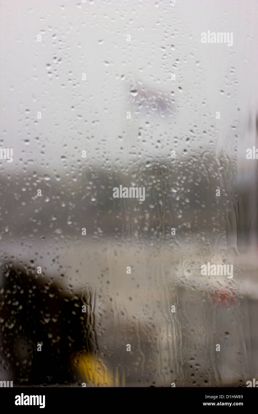 Rainy windows - abstract of flag on a windy and rainy day through a cafe windows in Waterhead, near Ambleside Stock Photo