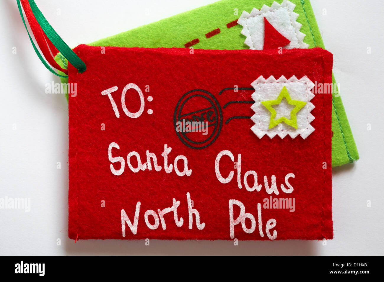 letter decorations addressed to Santa Claus North Pole post dated 24 Dec set on white background Stock Photo