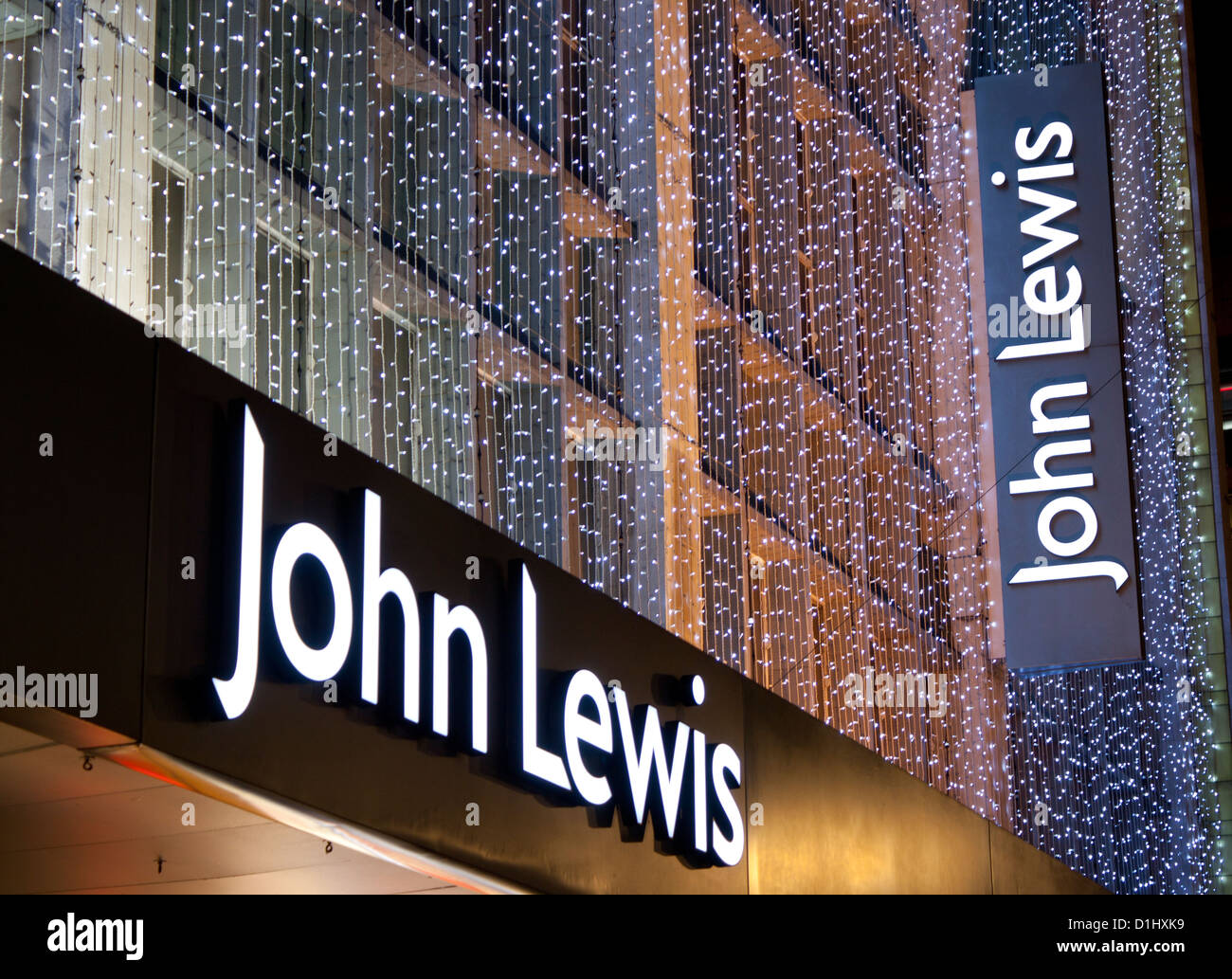 John Lewis department store signs with Christmas lighting / decorations at night / twilight / dusk Oxford Street London England Stock Photo