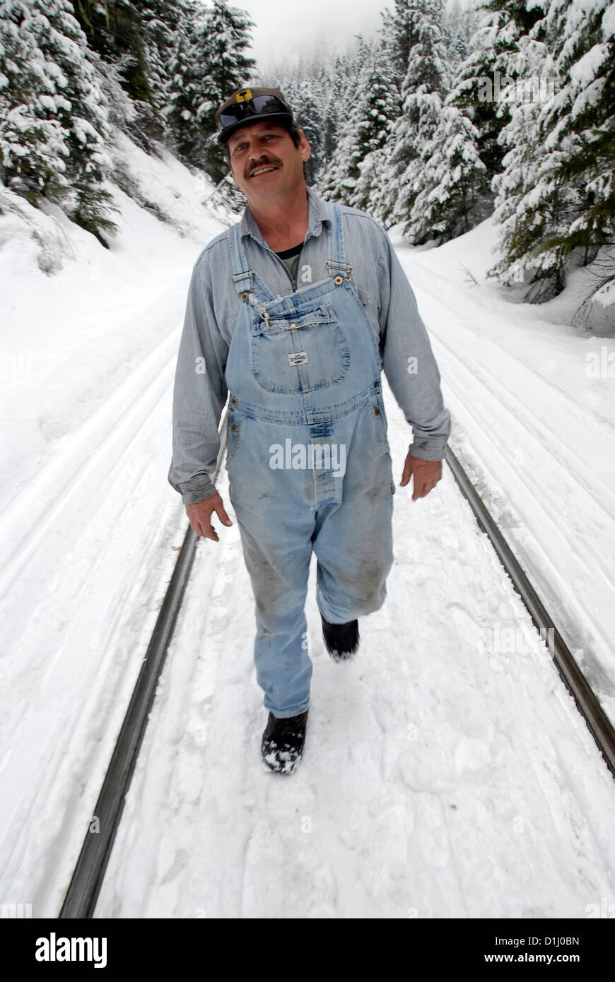 Railroad crew member walking the tracks in winter, Oregon Stock Photo