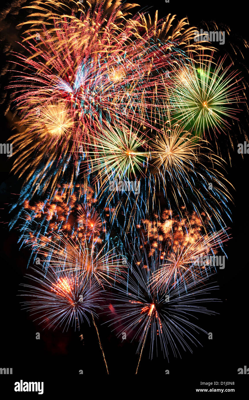 Fireworks display of multiple colors over dark background Stock Photo