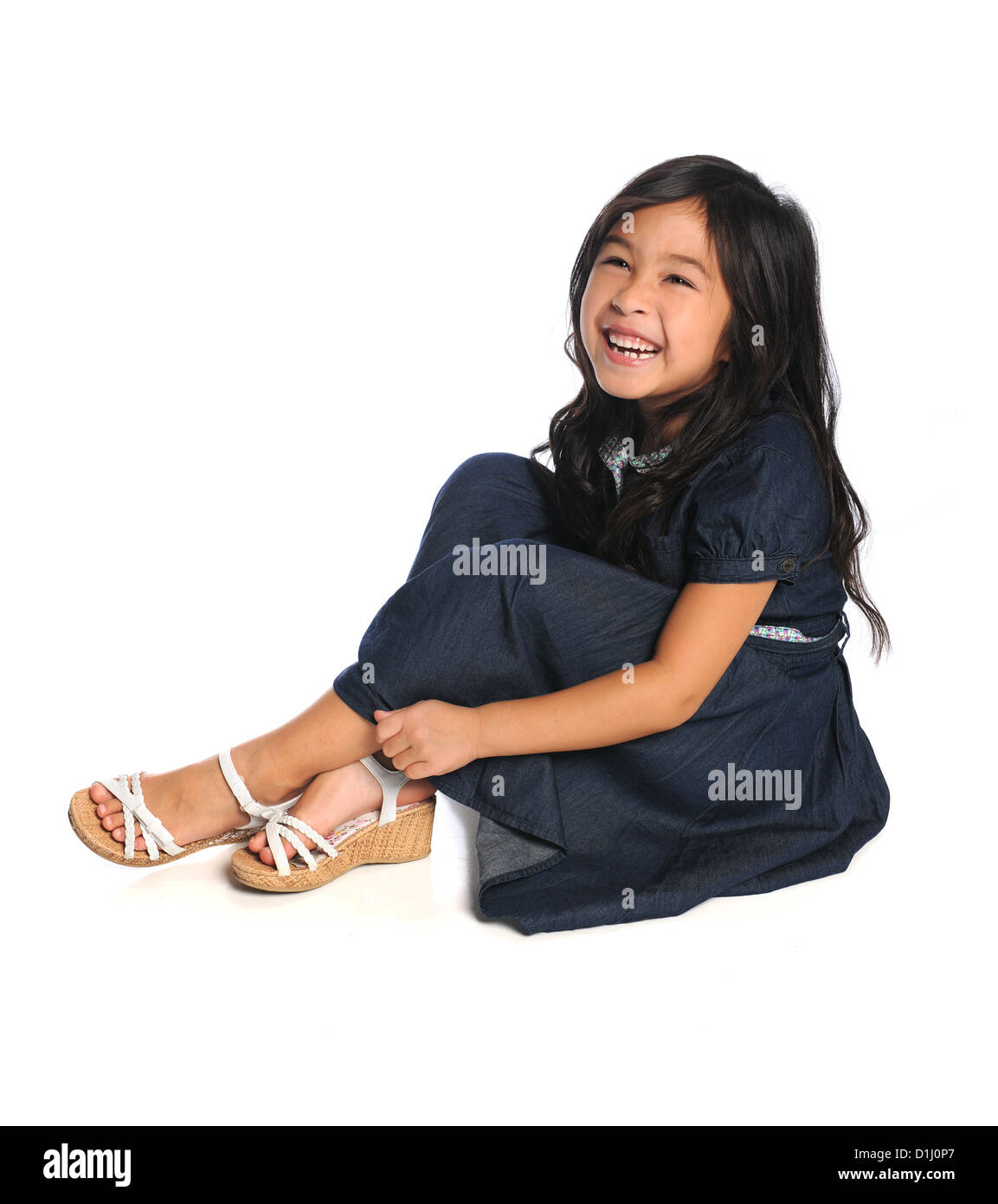 Portrait of Asian American girl smiling sitting over white background Stock Photo