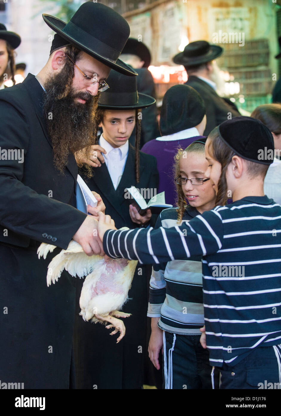 An ultra Orthodox Jewish children holds a chicken during the Kaparot ceremony held in Jerusalem Israel Stock Photo