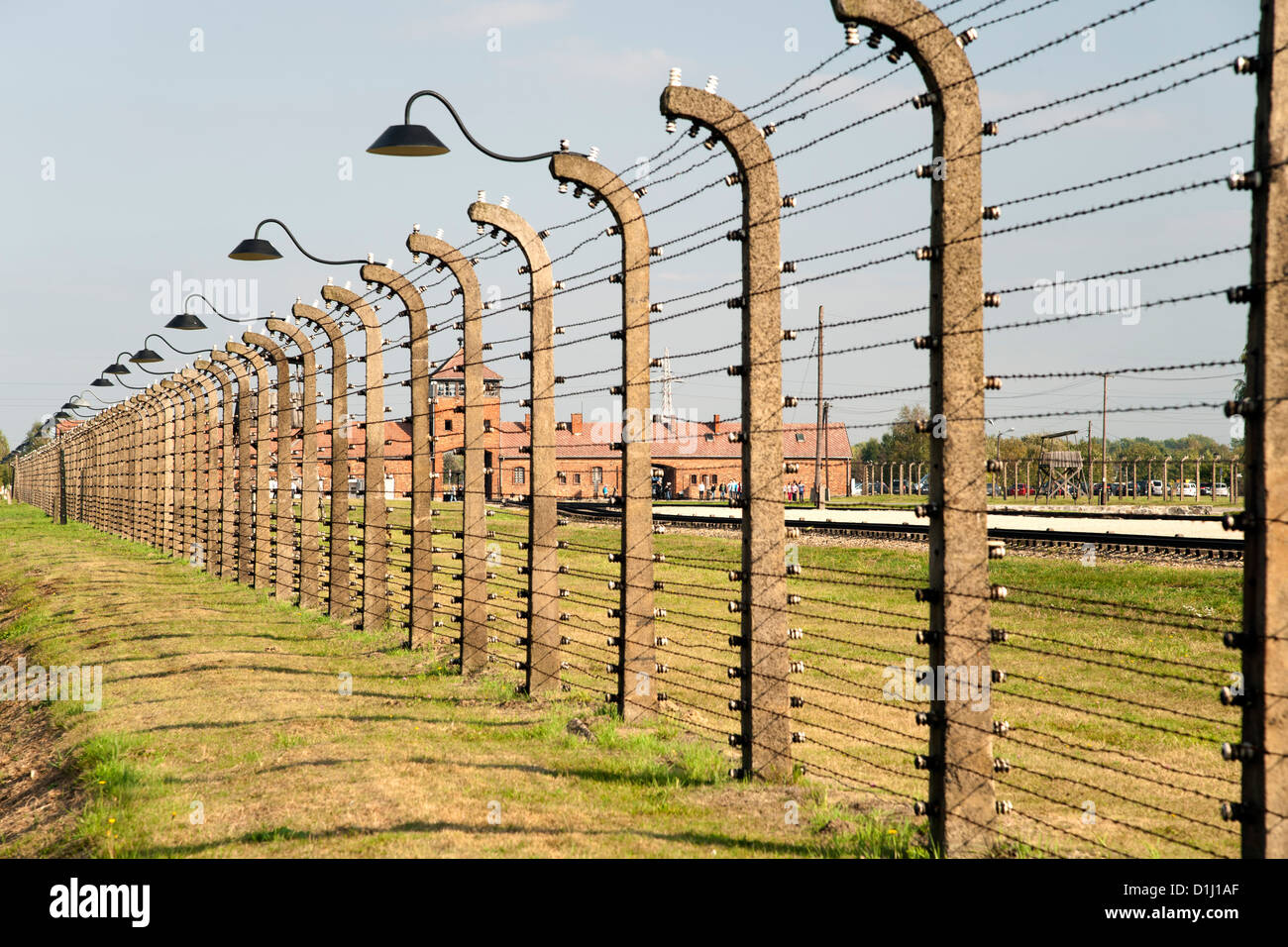 Electrified, barbed-wire fencing at the museum of the former Auschwitz II–Birkenau concentration camp in southern Poland. Stock Photo