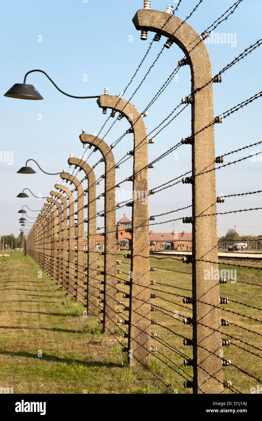 Electrified, barbed-wire fencing at the museum of the former Auschwitz II–Birkenau concentration camp in southern Poland. Stock Photo