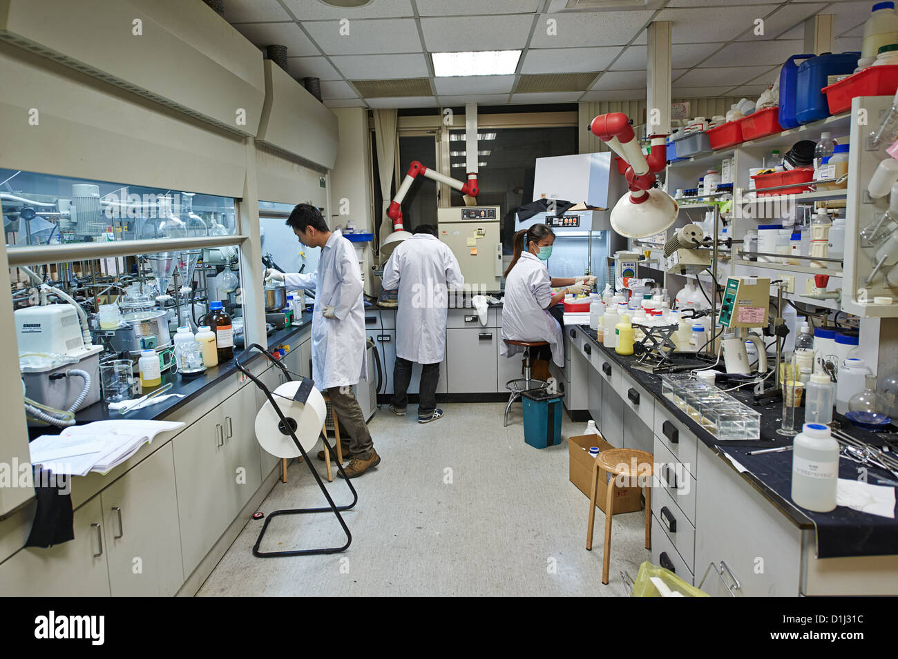 Lab workers researching ingredients and chemicals at a textile and fabric manufacture Stock Photo