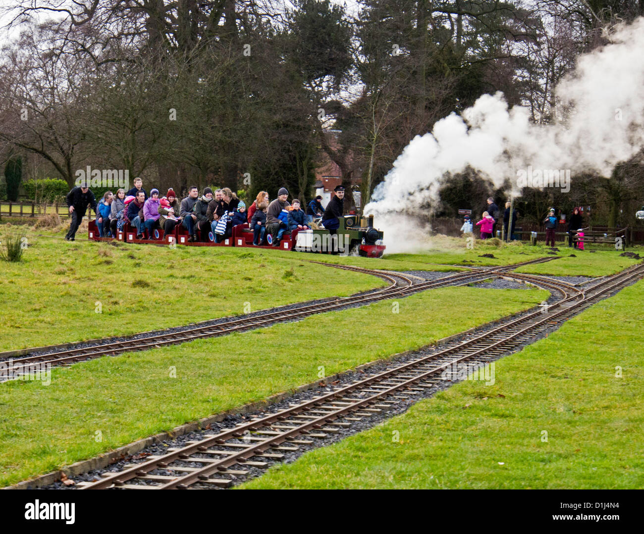 Leyland, UK. 23rd Dec, 2012. Model railway engine needing a little extra help up incline packed with families enjoying a ride on Leyland Model Railway, Worden Park, Leyland, Stock Photo