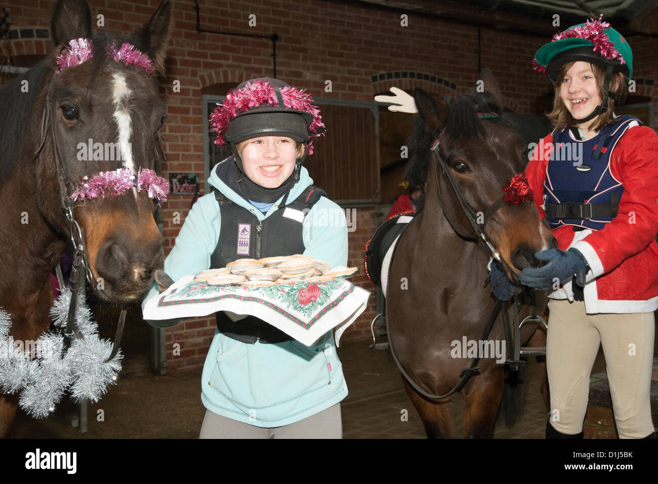 Ramsdell, Hampshire, UK. 24th Dec, 2012. Pony riding members of the Pitlands Posse tuck into Mince pies before leaving to sing Christmas carols around the village of Ramsdell Hampshire UK on Christmas Eve Stock Photo