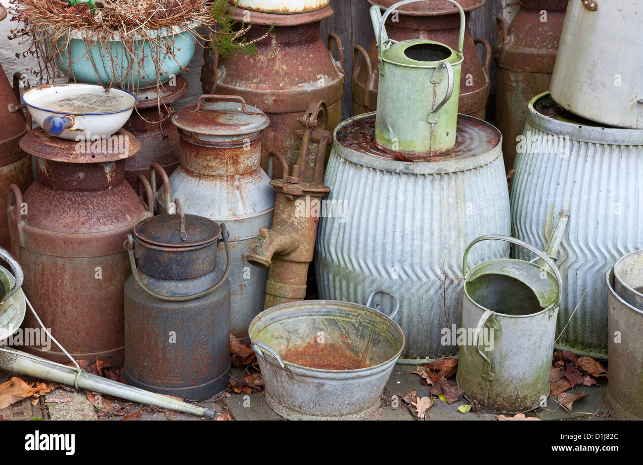 Old metal milk churns, watering cans, buckets etc Stock Photo