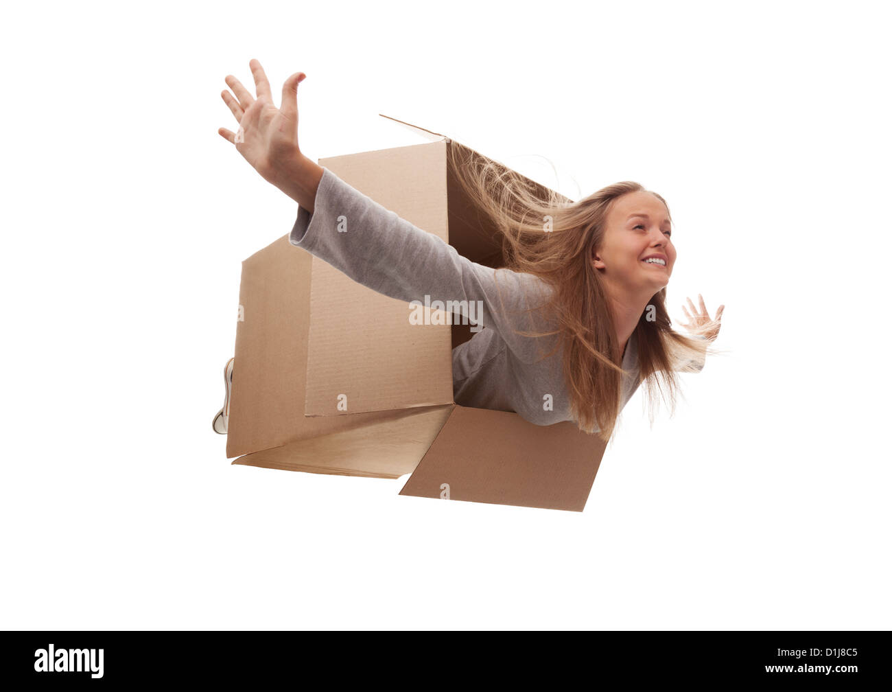 The girl in a cardboard box flies in white background Stock Photo