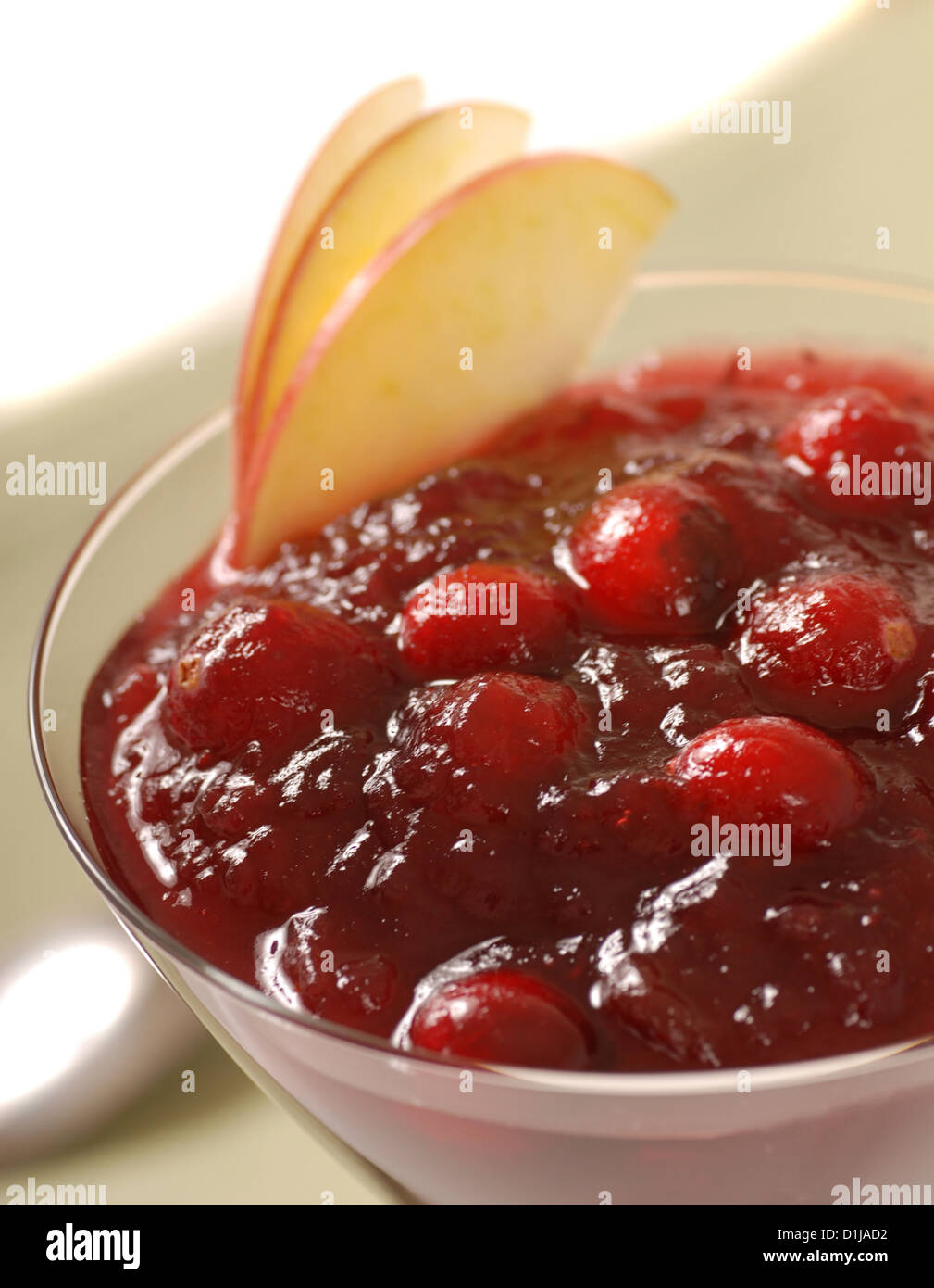 Fresh homemade cranberry sauce with apple slices in a martini glass Stock Photo