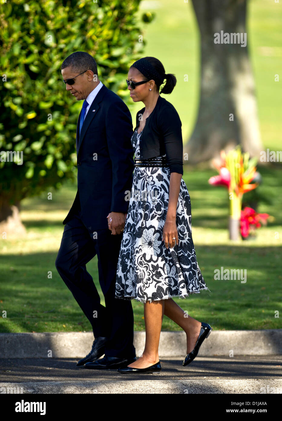 US President Barack Obama and First Lady Michelle walk to the memorial service in honor of Senator Daniel K. Inouye during a memorial service at the National Memorial Cemetery of the Pacific December 23, 2012 in Honolulu, HI. Stock Photo