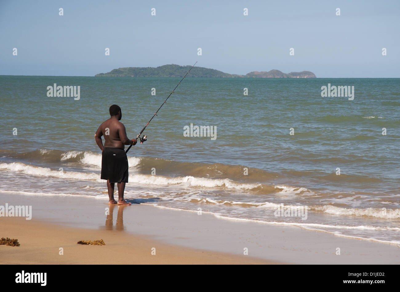 Aboriginal man fishing on Wonga Beach, north of Cairns, North
