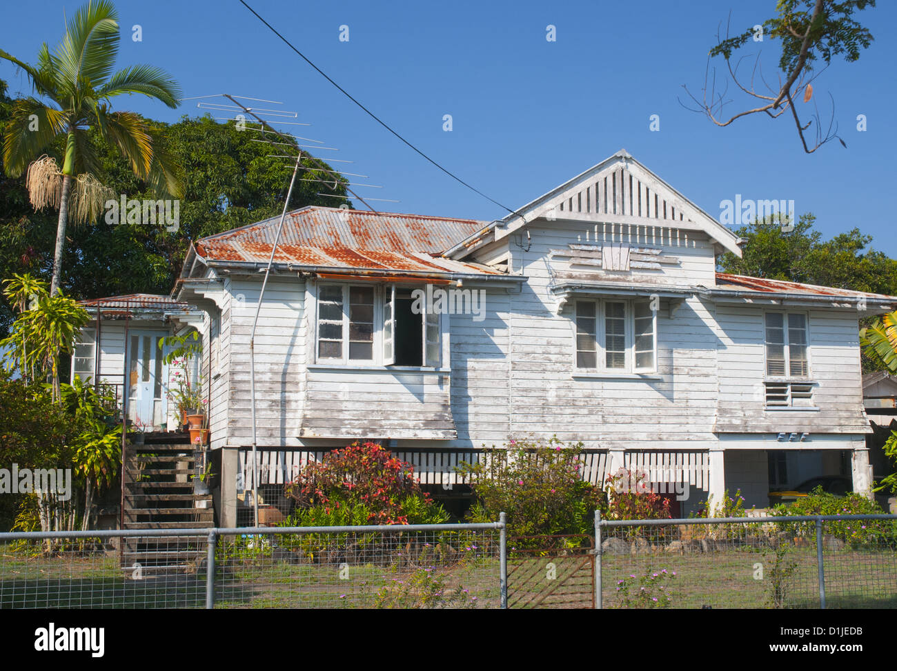 A old-fashioned Queenslander home raised on stilts, in tropical Cairns, North Queensland Stock Photo