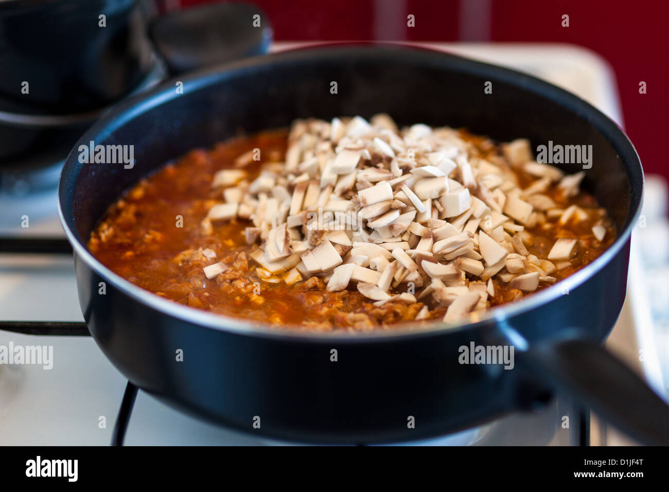 Closeup of stew cooking in pan on a stove Stock Photo - Alamy