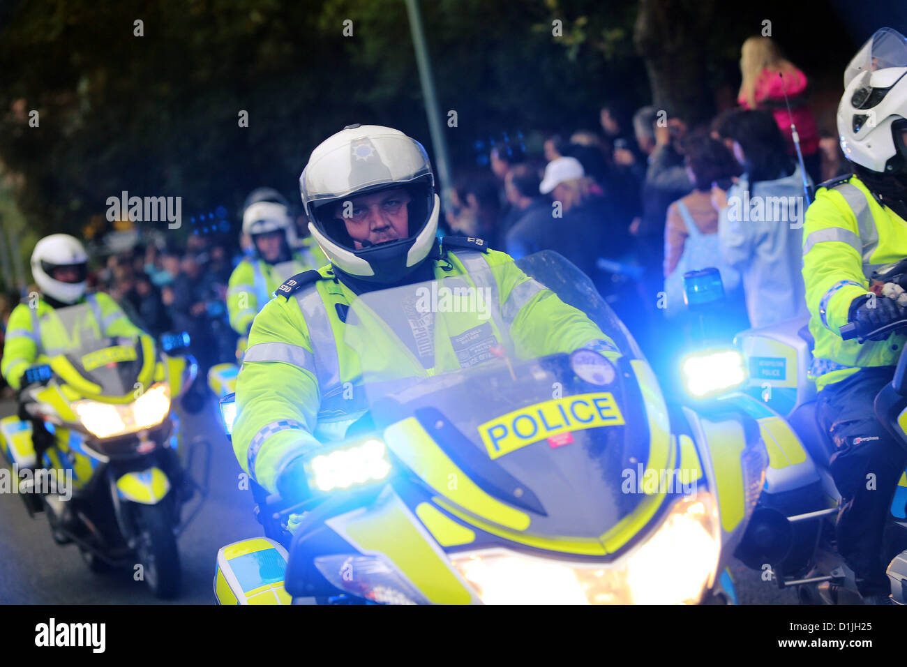 Sussex Police Motorbikes travel with blue lights flashing Stock Photo