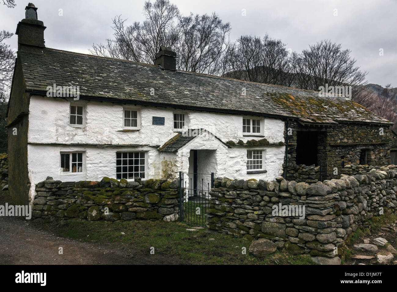 Old white washed farm cottage with slate roof and adjoining barn, Bridge End Cottage Farm,Little Langdale, Cumbria, England, UK Stock Photo