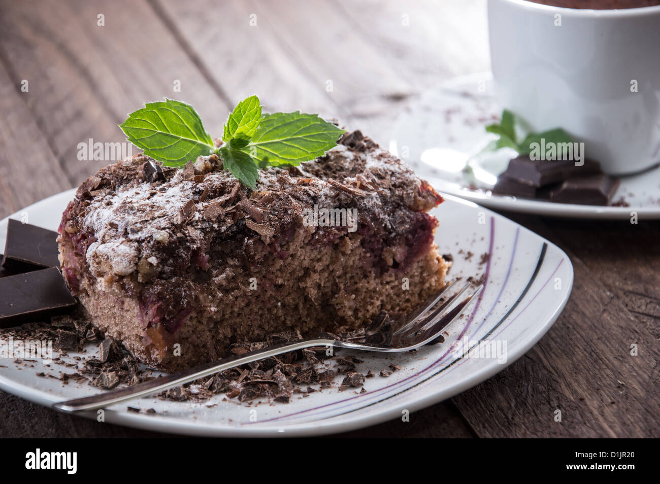 Piece of fresh baked Chocolate Cake on wooden background Stock Photo
