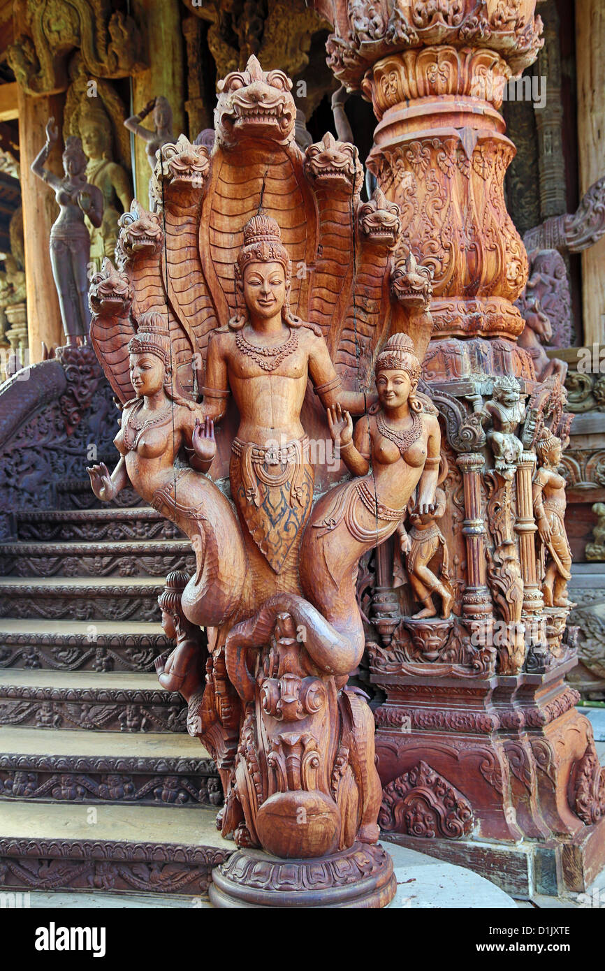 Wooden carving on the Sanctuary of Truth Temple, Prasat Sut Ja-Tum, Pattaya, Thailand showing a wood statue Stock Photo