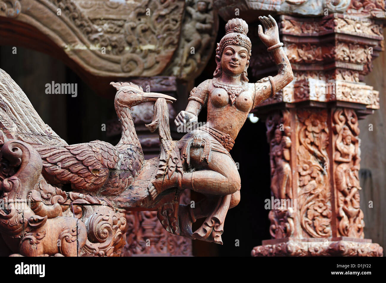 Wooden carving on the Sanctuary of Truth Temple, Prasat Sut Ja-Tum, Pattaya, Thailand showing a wood statue Stock Photo
