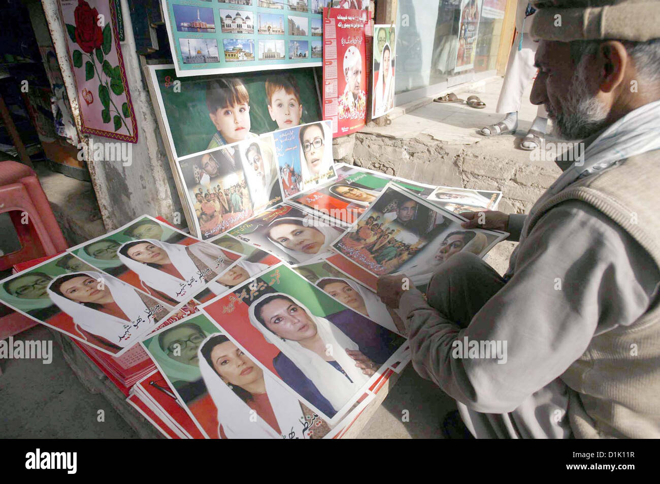 PESHAWAR, PAKISTAN, DEC 26: Man sells portraits of Benazir Bhutto to earn his livelihood  for support his family as the demand of such portraits increases across Pakistan on the occasion  of Benazir Bhutto Death Anniversary, in Peshawar on Wednesday, December 26, 2012.  (Fahad Pervez/PPI Images). Stock Photo