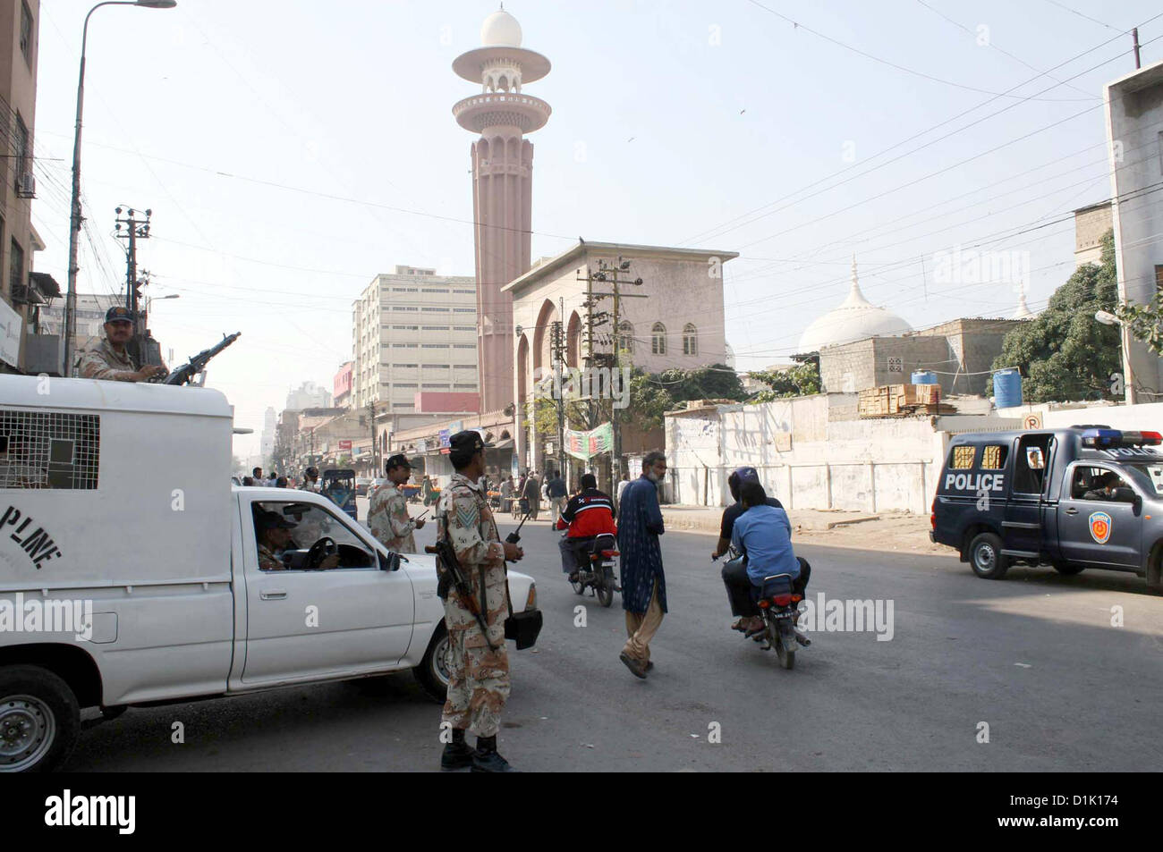 Rangers officials stand alert to avoid untoward incident due  to high-security alert during strike called by Ahle Sunnat Wal Jamat (Defunct Sipah-e-Sahaba)  against an assassination attack on their leader Aurangzeb Farooqi convoy and killing of his seven  gunmen and driver, at M. Jinnah road in Karachi on Wednesday, December 26, 2012. Stock Photo