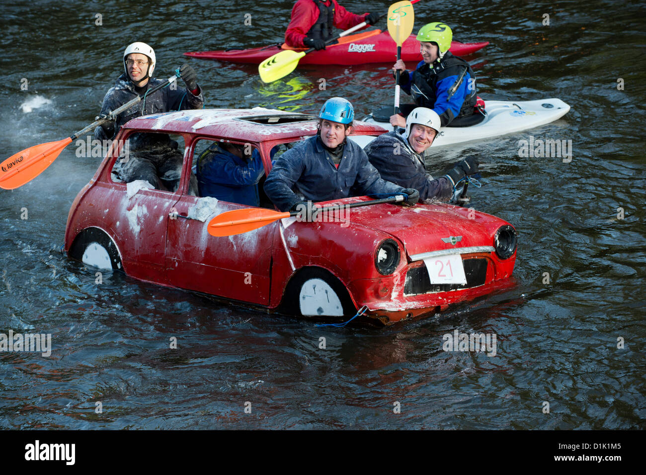 Matlock, UK. 26th Dec, 2012. A floating Mini car is pelted with flour bombs by spectators in the Matlock Raft race on Boxing Day. The charity event is organised by the Derbyshire Associtation of Sub-Aqua Clubs in aid of the RNLI. Stock Photo