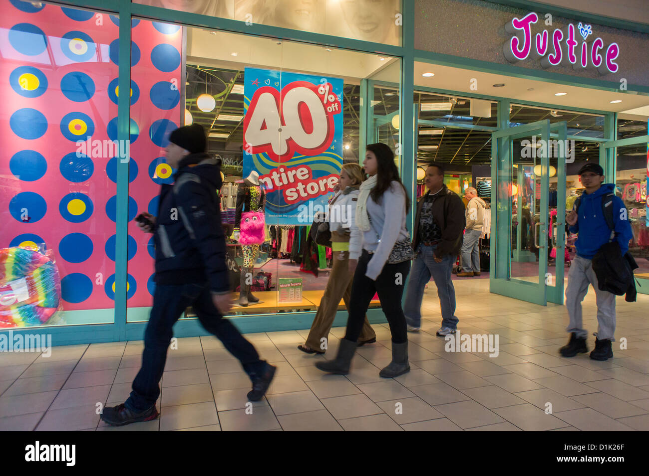 Crowds of last minute shoppers pack the Queens Center Mall in the